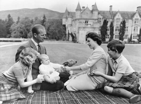 Queen Elizabeth II, Philip Duke of Edinburgh, and their 3 children, Princess Anne, the baby Prince Andrew, and Prince Charles.