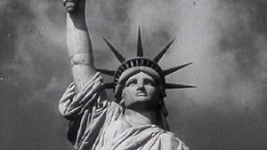 Behold the Statue of Liberty as a symbol of the American dream to hopeful immigrants arriving at Ellis Island