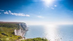 Explore the rugged coastline of the White Cliffs of Dover stretching along the English shore of the Dover strait